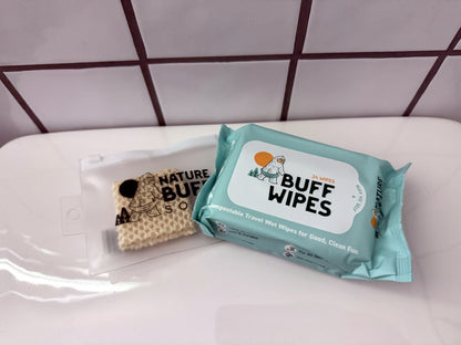 Buff Yo'Self camping hygiene kit with Buff Wipes biodegradable travel soap and reusable pouch in a bathroom